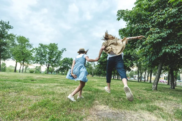 Young couple running through field — Stock Photo