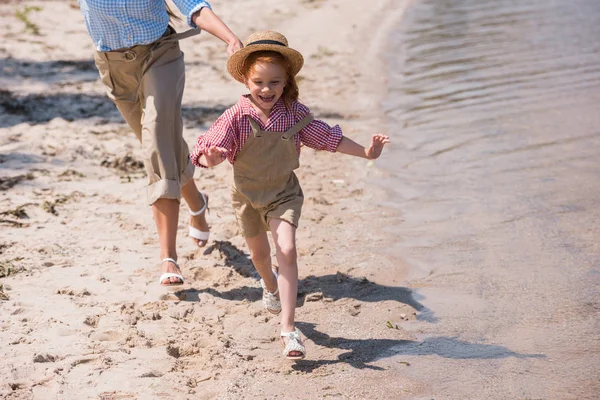 Mother and daughter running on beach — Stock Photo