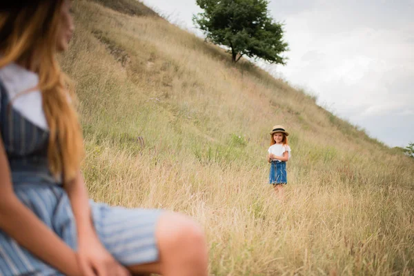 Mother and daughter on grassland — Stock Photo