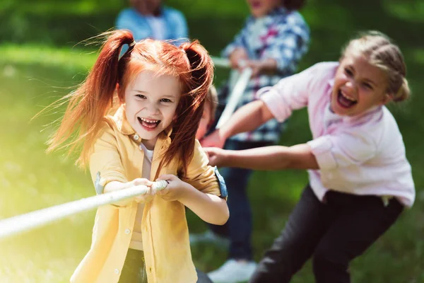 Multiethnic kids pulling rope — Stock Photo