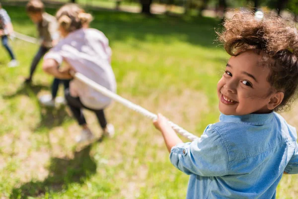 Children playing tug of war — Stock Photo