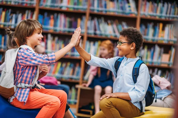 Schoolboys giving high five — Stock Photo