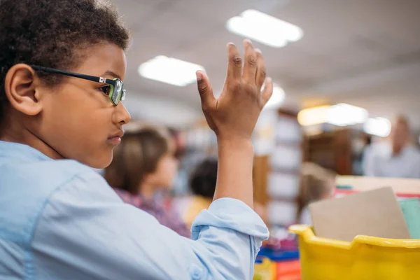 Schoolboy raising hand — Stock Photo