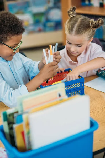 Kids choosing supplies in box — Stock Photo