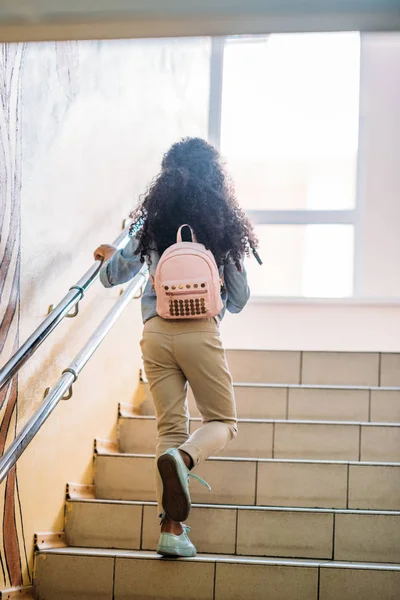 Adorable schoolgirl on stairs — Stock Photo
