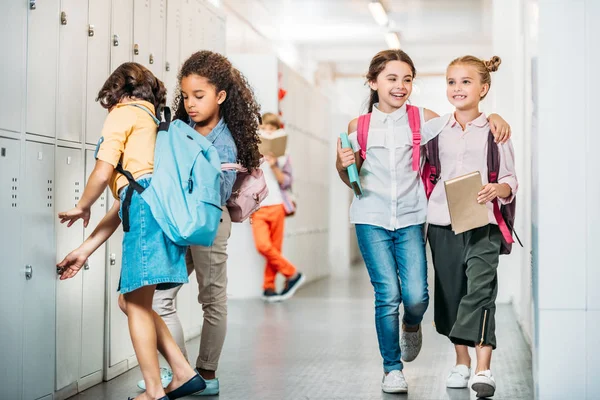 Schoolgirls walking through school corridor — Stock Photo