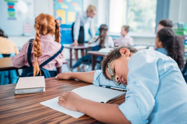 Schoolboy sleeping in class — Stock Photo
