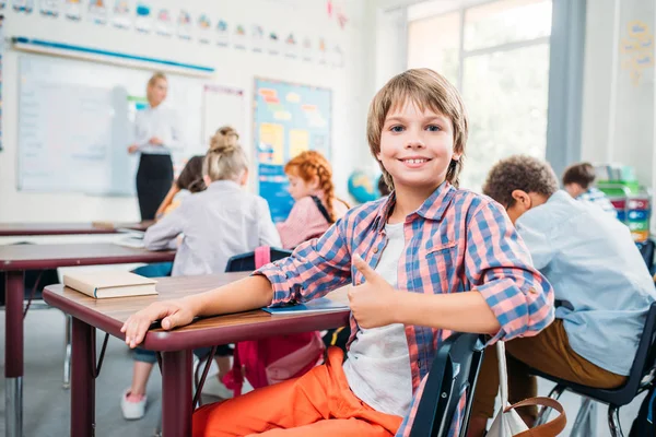 Schoolboy showing thumb up — Stock Photo