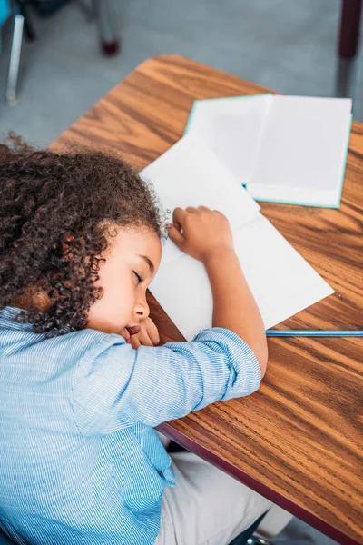 Overworked schoolgirl sleeping — Stock Photo