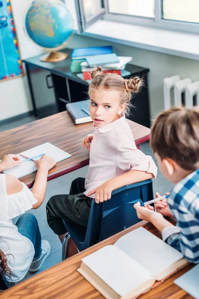 Schoolgirl talking to classmate — Stock Photo