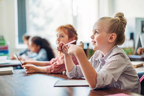 Schoolgirls sitting in class — Stock Photo