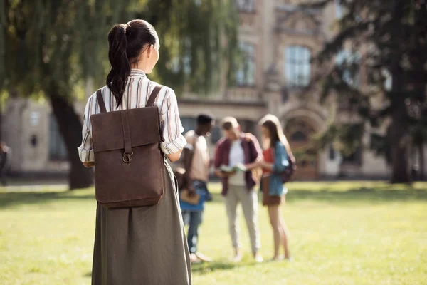 Female student looking at classmates — Stock Photo