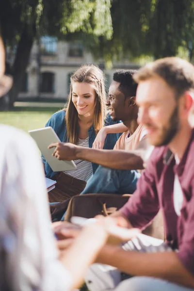 Multiethnic students with digital tablet — Stock Photo