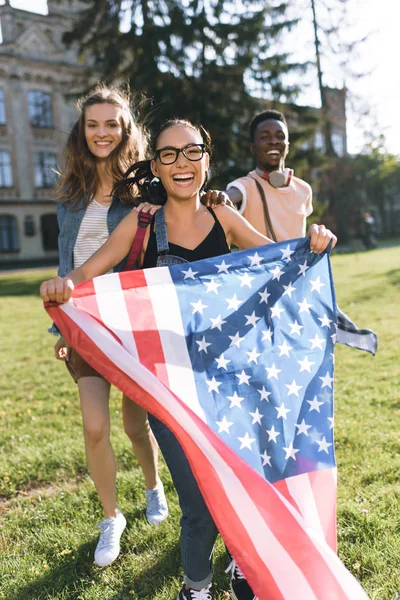 Multicultural friends with american flag — Stock Photo