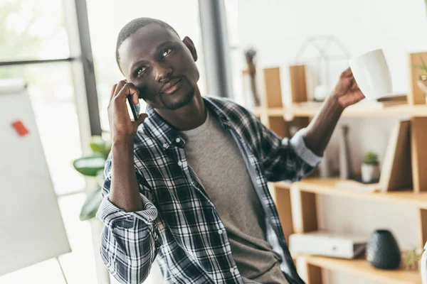 Young man talking by phone — Stock Photo