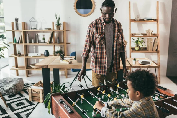 Father and son playing playing foosball — Stock Photo