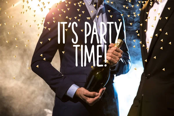 Stylish men with champagne bottle — Stock Photo