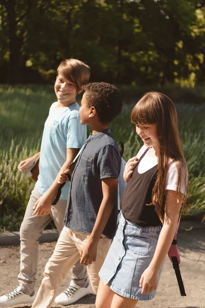 Multiethnic teens walking in park — Stock Photo