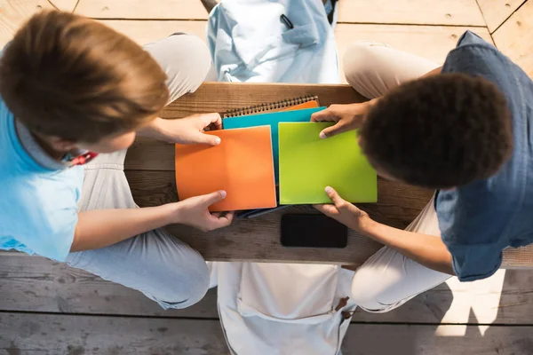 Boys studying on bench — Stock Photo