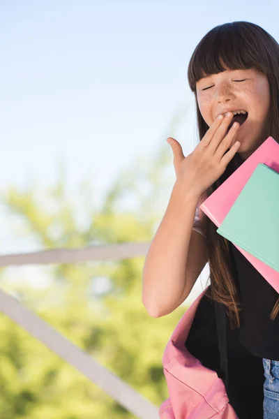 Yawning schoolgirl — Stock Photo