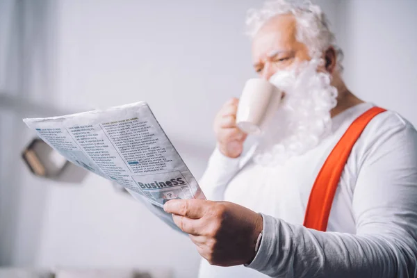 Santa claus reading newspaper — Stock Photo