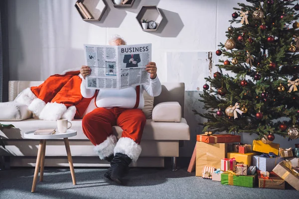 Santa claus reading newspaper — Stock Photo