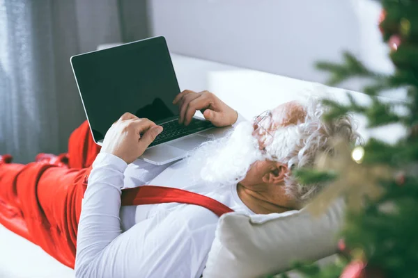 Père Noël en utilisant un ordinateur portable — Photo de stock