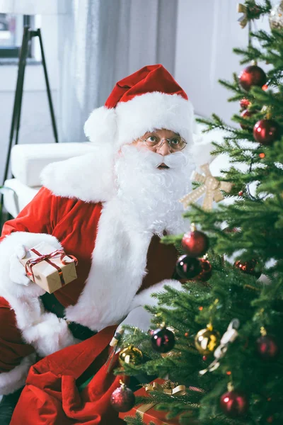 Santa claus with christmas gift — Stock Photo