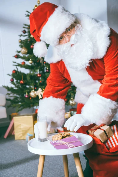 Santa claus stealing cookies — Stock Photo