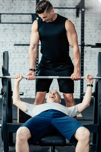 Senior sportsman lifting barbell — Stock Photo