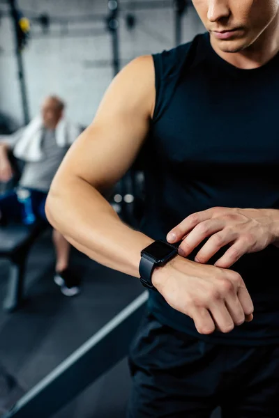 Sportsman looking at smartwatch — Stock Photo