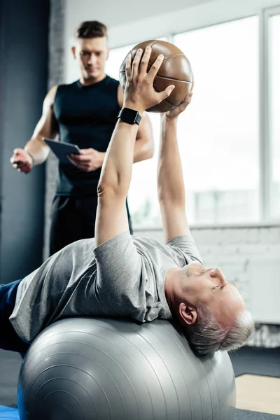 Senior sportsman training with medicine ball — Stock Photo