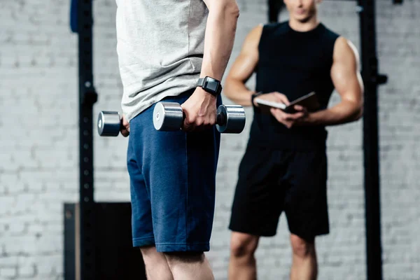 Sportsman training with dumbbells — Stock Photo