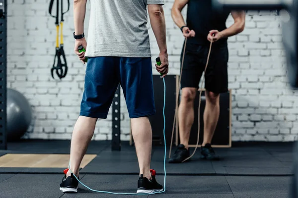 Sportsmen training with skipping rope — Stock Photo
