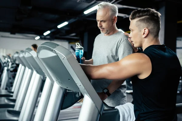Senior sportsman training on treadmill — Stock Photo