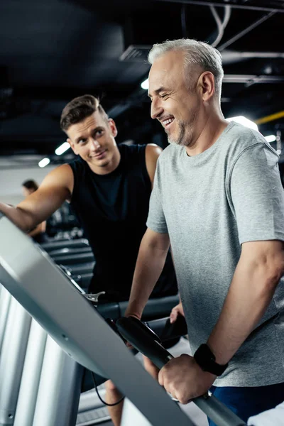 Senior sportsman on treadmill — Stock Photo