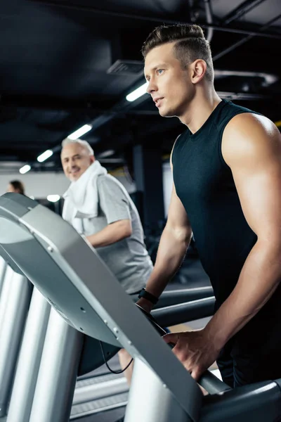 Sportsman training on treadmill — Stock Photo