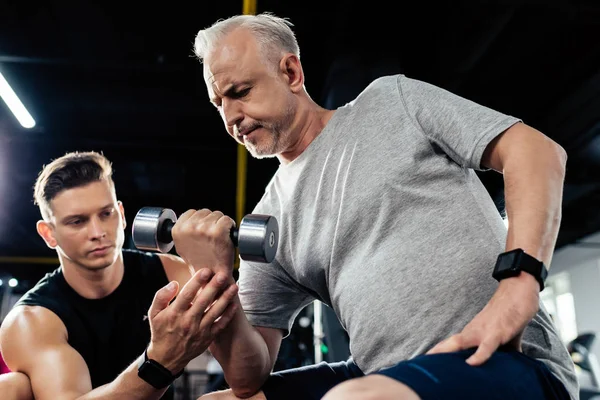 Senior sportsman with dumbbell — Stock Photo