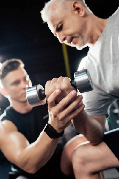 Senior sportsman with dumbbell — Stock Photo