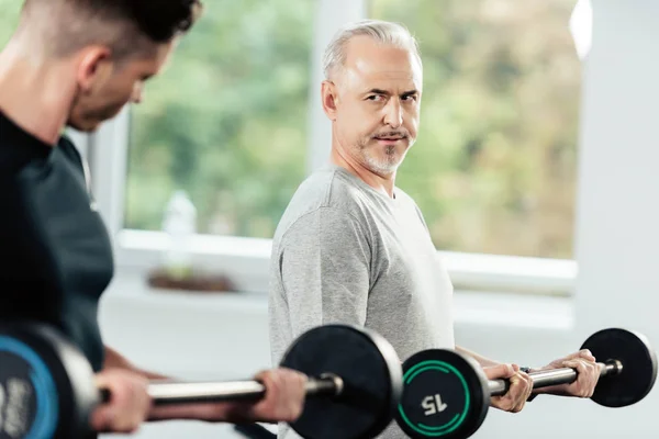 Sportsmen training with barbells — Stock Photo