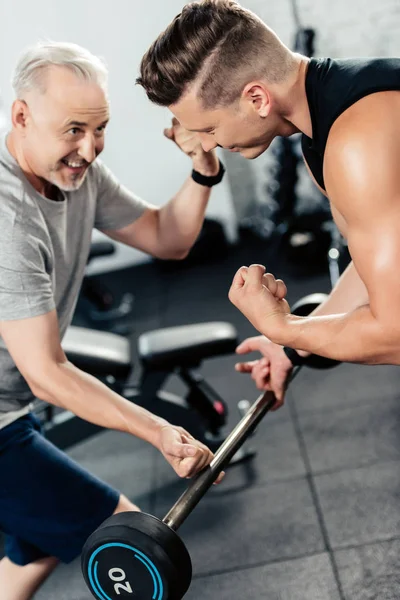 Senior sportsman with barbell — Stock Photo