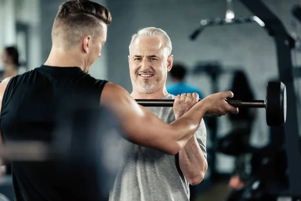 Senior sportsman with barbell — Stock Photo