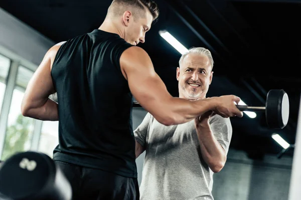 Sportsman training with barbell — Stock Photo