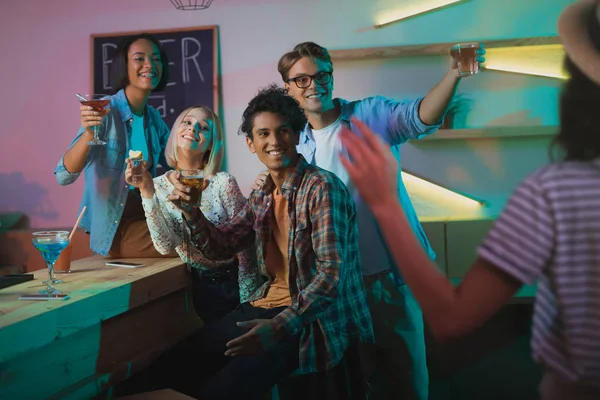 Multicultural people greeting friend at party — Stock Photo