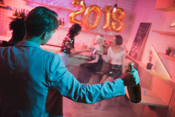 Man brought bottle of champagne on party — Stock Photo