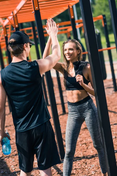 Woman giving high five to trainer — Stock Photo