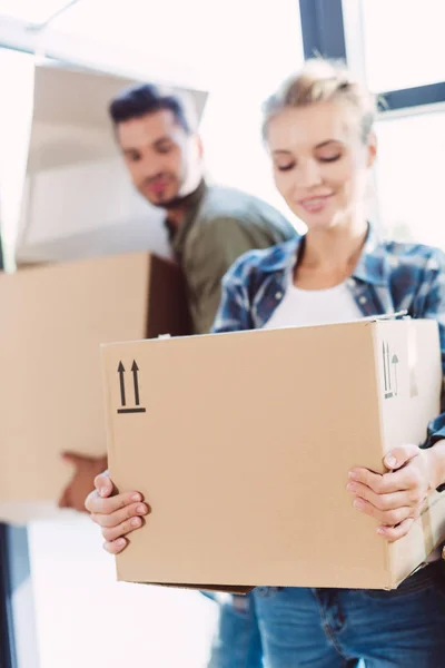 Couple with cardboard boxes in new house — Stock Photo