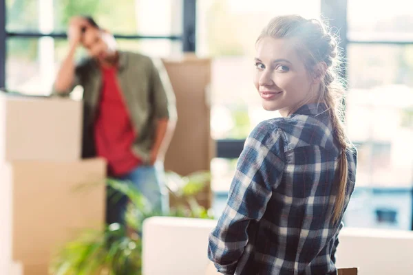 Couple with cardboard boxes in new house — Stock Photo