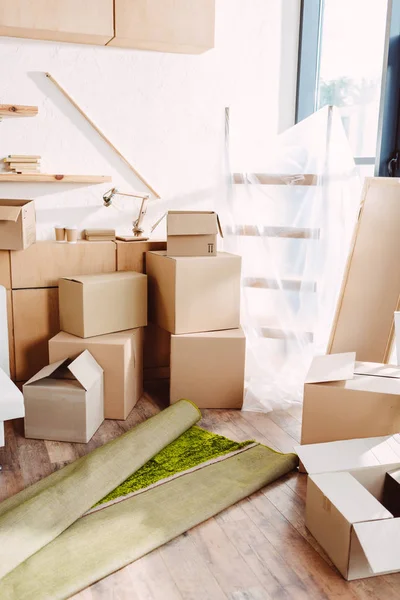 Cardboard boxes in new house — Stock Photo