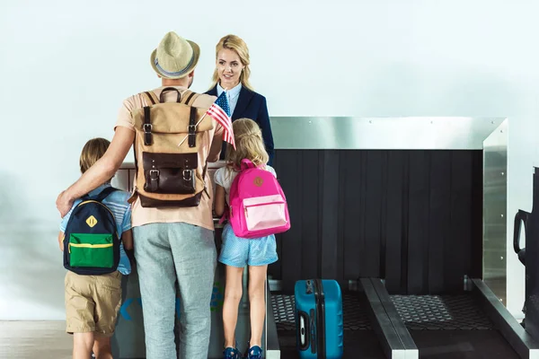 Семья на стойке регистрации в аэропорту — стоковое фото